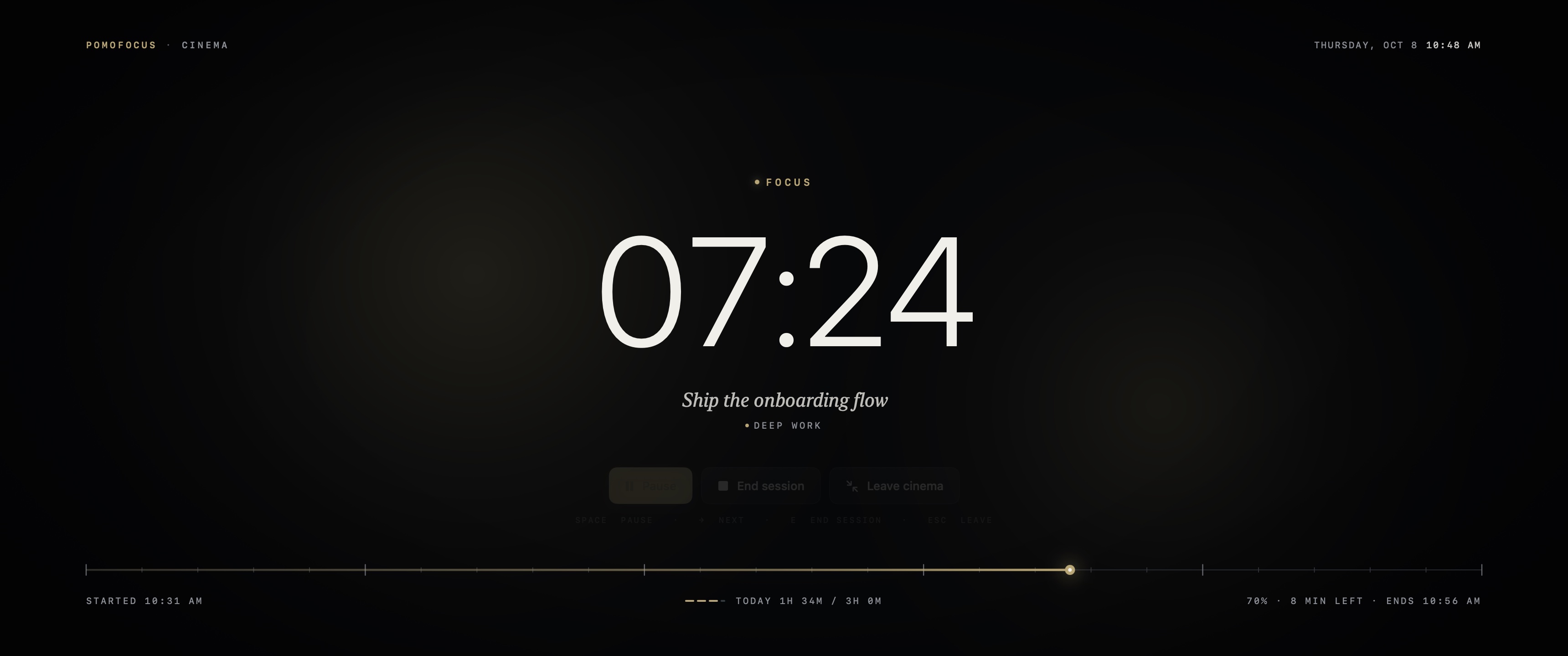 Cinema mode on a 3440 by 1440 ultrawide display: a large countdown, the current intention in serif italics, and a gold minute tape across the bottom